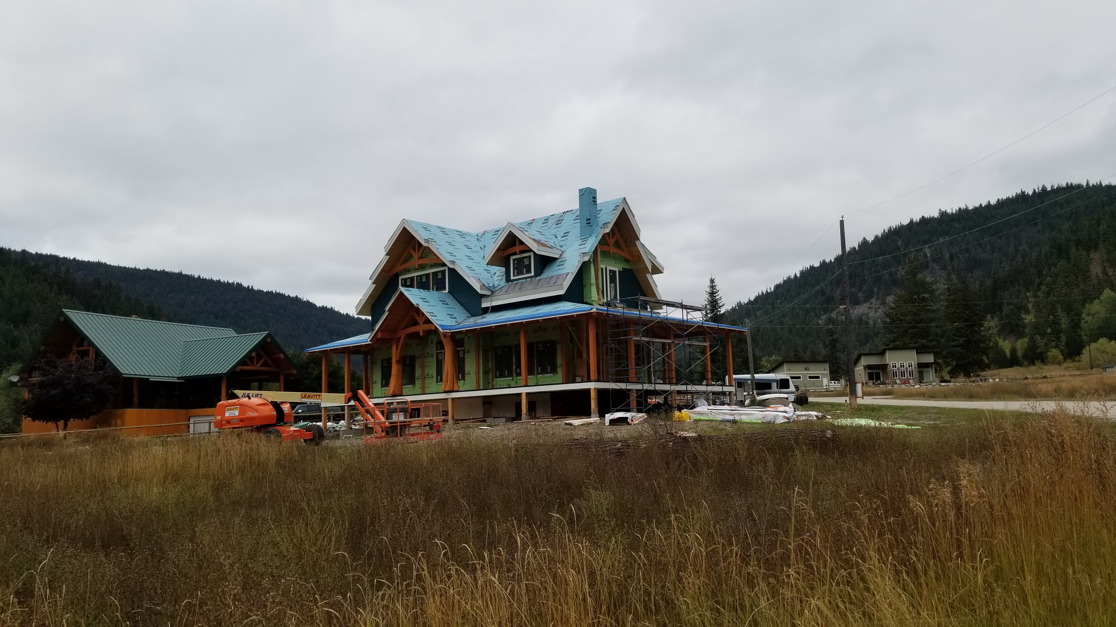 Allison Lake Residence — front elevation under construction with timber frame detailing
